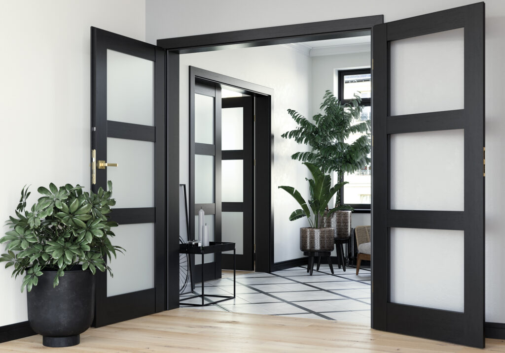 Elegant interior featuring black framed doors with frosted glass panels and luxurious gold handles, adding a touch of sophistication to the modern design.