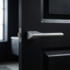 Sleek satin chrome Lupina on Hidden Rosette hidden modern internal door handles with a smooth brushed texture on a contemporary black interior door.