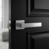 Sleek satin chrome Pina on Square Rosette elegant square internal door handles with a smooth brushed texture on a modern black door.