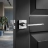 High-shine polished chrome Setia on Square Rosette classic square internal door handles featuring a mirror-like finish on a dark charcoal interior door.