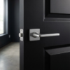 Classic square internal door handles in a sleek satin chrome finish from the Setia collection, installed on a minimalist black door for a contemporary contrast.
