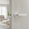 Elegant internal door handles with the Alora lever on a round rosette in a matt white finish, blending seamlessly with a light timber internal door.