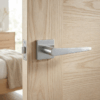 Arnica on Square Rosette in satin chrome, a brushed premium internal door handle on a light oak internal door.