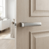 Brisa on Hidden Rosette in satin chrome, showcasing durable internal door handles on a light oak interior door.