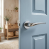 Polished chrome Dalia on Round Rosette, reflecting light beautifully and demonstrating premium designer internal door handles on a blue internal door.