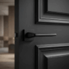 Erba on Square Rosette in matt black finish, showcasing modern square internal door handles on a dark panelled internal door.