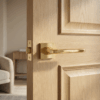 Erba on Square Rosette in premium PVD gold, elegant modern square internal door handles on a natural wood internal door.