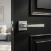 Erba on Square Rosette in satin chrome, sleek modern square internal door handles mounted on a black interior door.