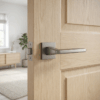 Erba on Square Rosette in titanium finish, durable modern square internal door handles fitted to an oak internal door.