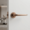 Hiacynta on Round Rosette in PVD copper, offering retro-style internal door handles on a white modern interior door.