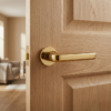 Inula on Round Rosette in PVD gold, adding a premium touch to sophisticated internal door handles on wooden doors.