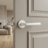Matt white Irga on Round Rosette, premium round internal door handle paired with a soft grey interior door.