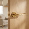 PVD gold Irga on Round Rosette, premium round internal door handle installed on a light oak interior door.