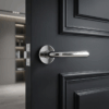 Polished chrome Irga on Round Rosette, premium round internal door handle on a modern black interior door.