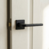 Ismena luxury square internal door handles in a matt black finish, shown on a light internal door for a bold, contemporary interior look.
