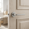 Lira on Round Rosette in satin chrome, displaying luxury round internal door handles on a light oak interior door.