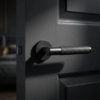 Molinia on Round Rosette in matt black on a dark interior door, capturing the look of understated round door handles with modern texture.