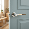 Delicate round internal door handles – Ninfea on Round Rosette in polished chrome, fitted to a blue panel door in a bright modern interior.