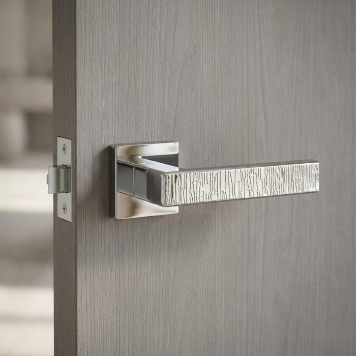 Amarylia - Polished Chrome - Grey Door Amarylia on Square Rosette in polished chrome, featuring modern designer door handles with a textured lever on a grey interior door.