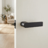 Sorella on Hidden Rosette in matt black, featuring a contemporary door handle design on a light interior door.